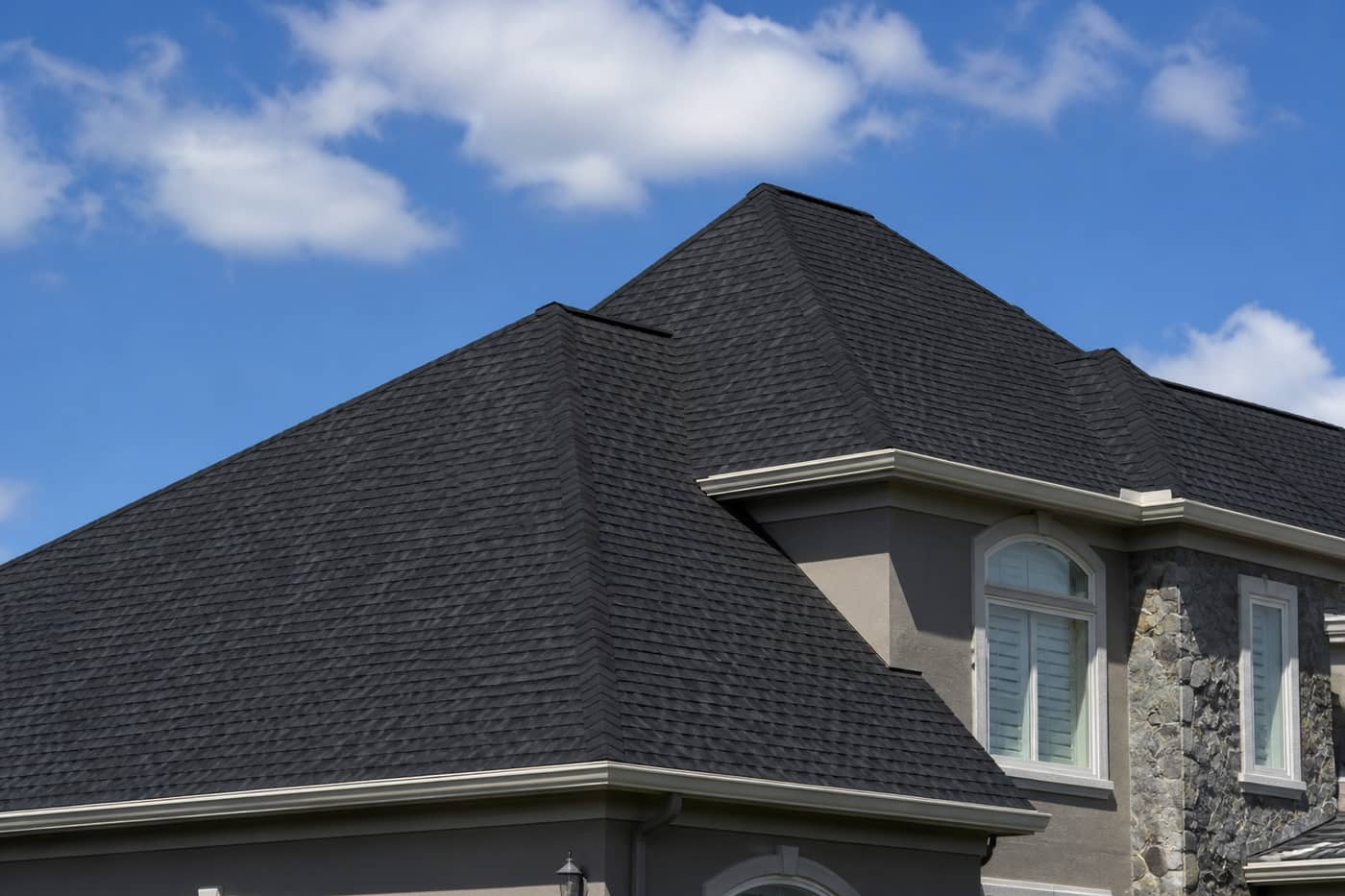 Roofer inspecting flashing on a residential roof